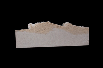 Torn paper edge isolated on a black background for designs. Ripped paper piece closeup photo.