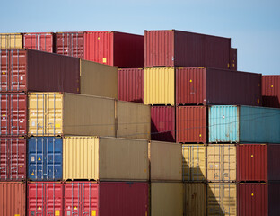 Fototapeta premium Stacks of large iron cargo containers for transporting import and export of various goods by sea vessels in industrial port, sea freight trade international transportation, logistics concept.