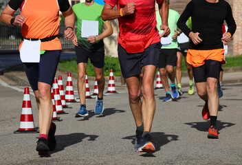 Fototapeta na wymiar runners during the marathon on the city streets run in sneakers