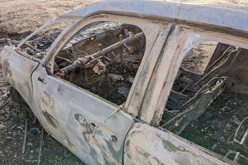Car after the fire. Iron parts of burnt out car. Completely burnt passenger car due to accident,...