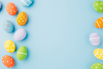 Colorful easter eggs isolated on blue background with copy space, Funny decoration, Creative composition banner web design holiday background, Happy Easter Day greeting card, flat lay top view