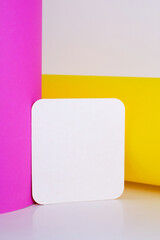 Blank white card isolated on pink and yellow background. Place for text. Mock up greeting card. Form
