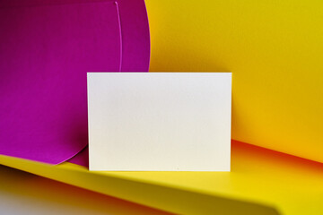 Blank white card isolated on pink and yellow background. Place for text. Mock up greeting card. Form
