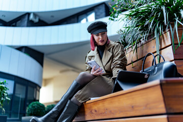 Fashion editor double-checking her pitch on a tablet before a business meeting, modern girl in a business world