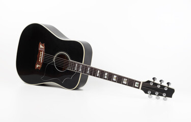 Musical instrument - vintage black acoustic guitar white background