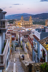Cityscape of the Andalusian city of Jaen at dusk, with the cathedral to be recognized among the rooftops. - 580416947
