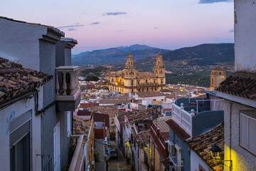 Cityscape of the Andalusian city of Jaen at dusk, with the cathedral to be recognized among the rooftops. - obrazy, fototapety, plakaty