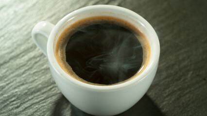 Macro Shot of Coffee Drop Falling into Fresh Espresso Cup