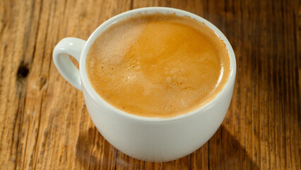 Macro Shot of Coffee Drop Falling into Fresh Espresso Cup