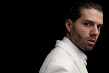 Obraz premium close up picture of sexy young man wearing white suit and posing