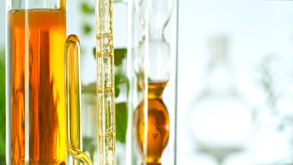 Getting essential oil from natural substances and flowers. Yellow oil flows in a spiral.