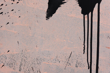 Messy black paint strokes and smudges on an old painted wall background. Abstract wall surface with...