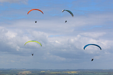 Paragliders flying from a hill
