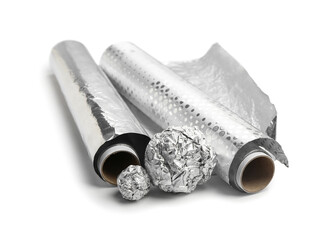 Rolls and balls of aluminium foil on white background