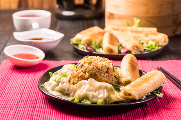Chinese style meal - gyoza dumplings, spring rolls and rice
