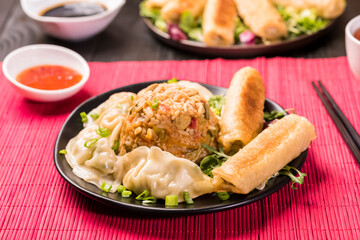 Chinese style meal - gyoza dumplings, spring rolls and rice