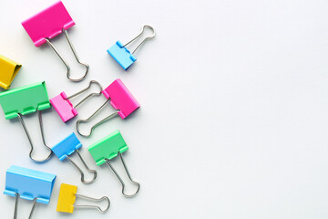 Colorful binder clips on grey background