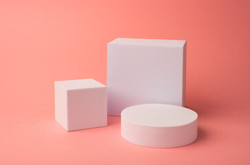 White geometric figures on a salmon color background. A podium for cosmetic products. Background for branding and packaging presentation.