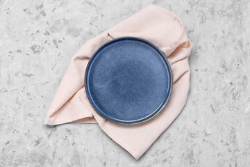 Empty plate and napkin on grunge background