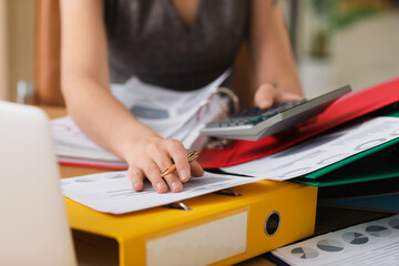 Female accountant working with calculator and documents at table in office, closeup - obrazy, fototapety, plakaty
