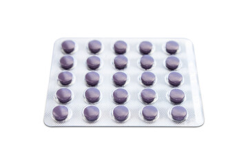 Small violet blister pills isolated on white background.