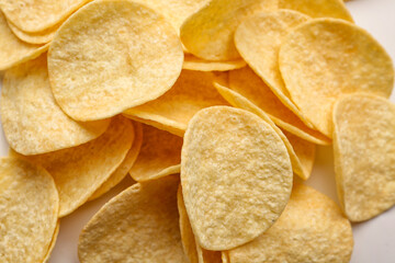 Delicious potato chips on white background, closeup