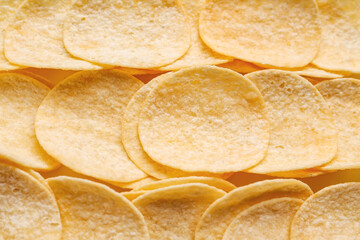 Delicious potato chips as background