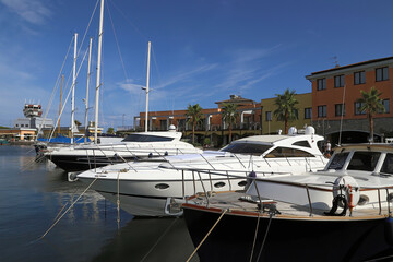 Italy, Genoa. Front perspective of Luxury yachts and sailing boats moored at Marina Genoa Airport against a nice blue sky. This new marina is connected to Genoa Airport. 