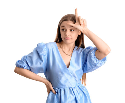 Young woman in dress showing loser gesture on white background