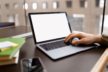Freelancer copywriter using laptop typing on keyboard , working on online project, sitting at workplace. Student learning, exam preparation, online education, selective focus. Mockup