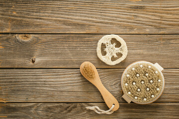 Dry massage brushes on wooden background, top view, spa composition with massage natural brushes.