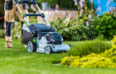 Man Mowing His Backyard Garden Grass - 580433114