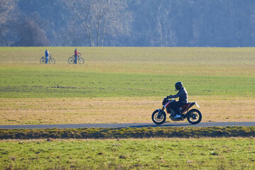 Unidentified man with helmet riding a motorcycle on the countryside