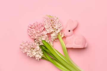 Beautiful hyacinth flowers and Easter bunny on pink background
