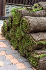 stacks of sod rolls for new lawn