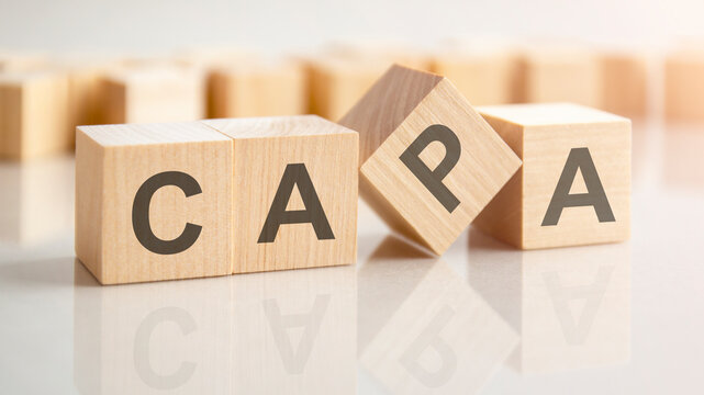 text CAPA on wooden blocks, background have blur effect