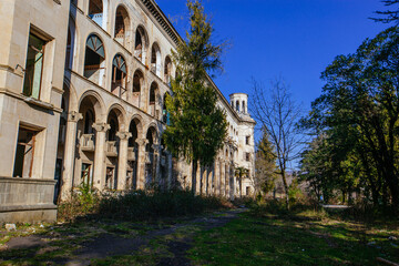 Fototapeta na wymiar Ruined overgrown old abandoned Soviet sanatorium Iberia, Tskaltubo, Georgia