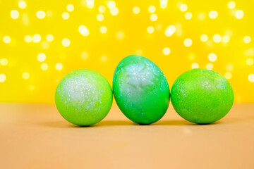 Bright colored Easter eggs on a yellow background. Easter concept.