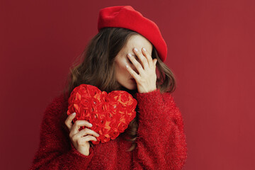 sad elegant 40 years old woman in red sweater and beret