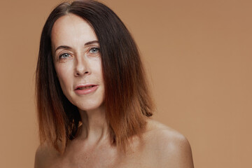 Portrait of modern woman against beige background