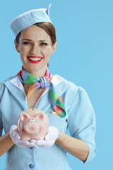 smiling modern female stewardess on blue