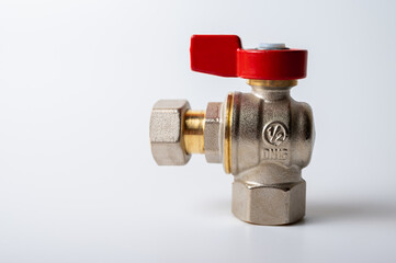 brass metal water faucet with red valve, different angle isolated on light background close up, plumbing connection
