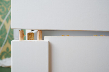 Broken white retractable box of cabinet. furniture repair