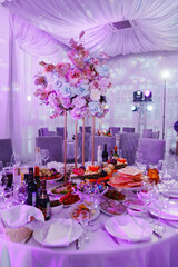 decoration of the served table with a bouquet on a stand