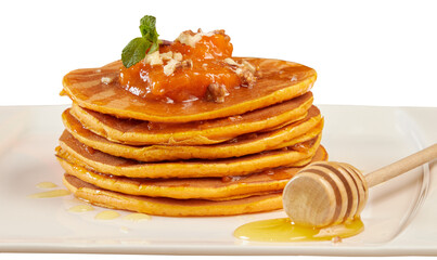Delicious pancakes with jam, honey or maple syrup. Homemade pancakes and a wooden spoon in isolation on a white plate