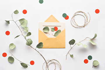 Eucalyptus Twigs in a Flat Lay on White Paper with an Envelope, Orange Circles and Cord