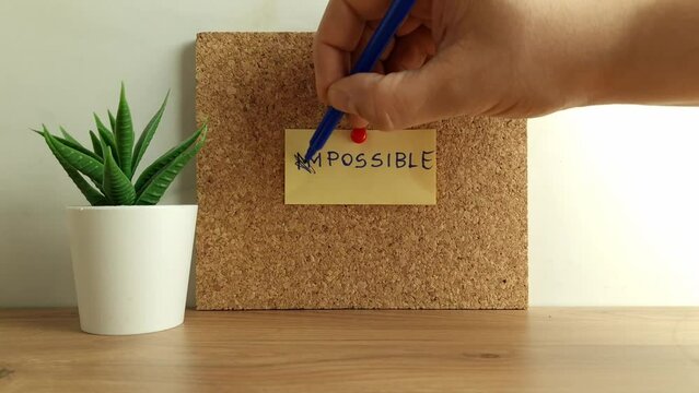 Businessman`s hand changing word impossible to possible. Motivational, inspirational concept