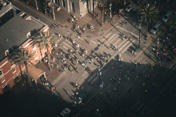 Aerial shots of pedestrians streaming across canal street, new Orleans, in the early evening sun...