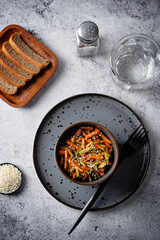 Asian cucumber carrot salad with sesame seeds in a bowl