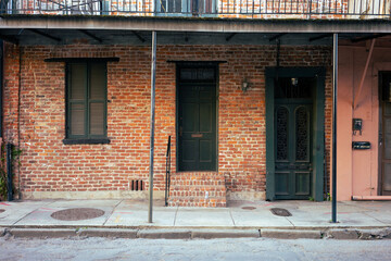 A classic house in the New Orleans French Quarter with a beer on its front step - Landscape